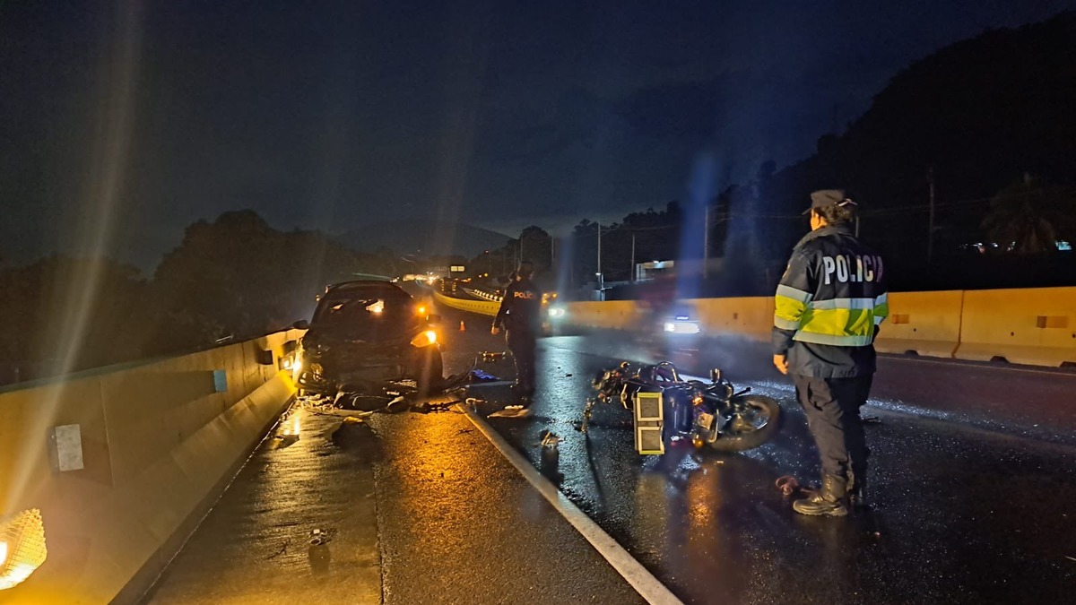 Agentes de la PNC junto a una motocicleta y un carro dañados sobre la carretera a Sonsonate, en el km 33, Armenia